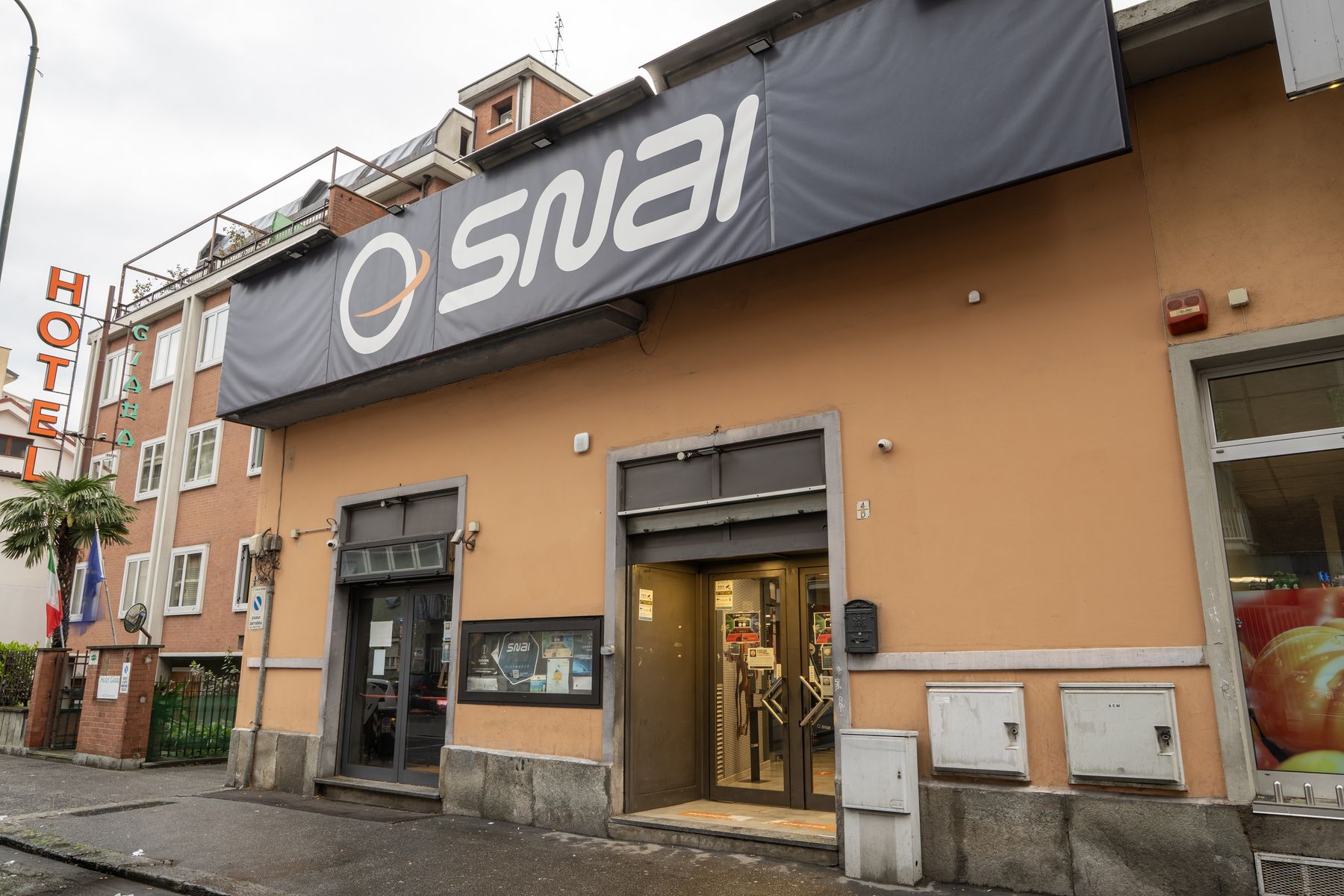 Interno agenzia scommesse con schermi sportivi
